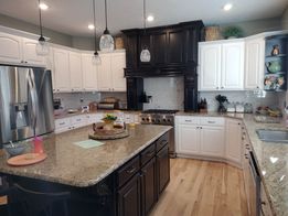 Kitchen with contrasting light and dark cabinet finishes